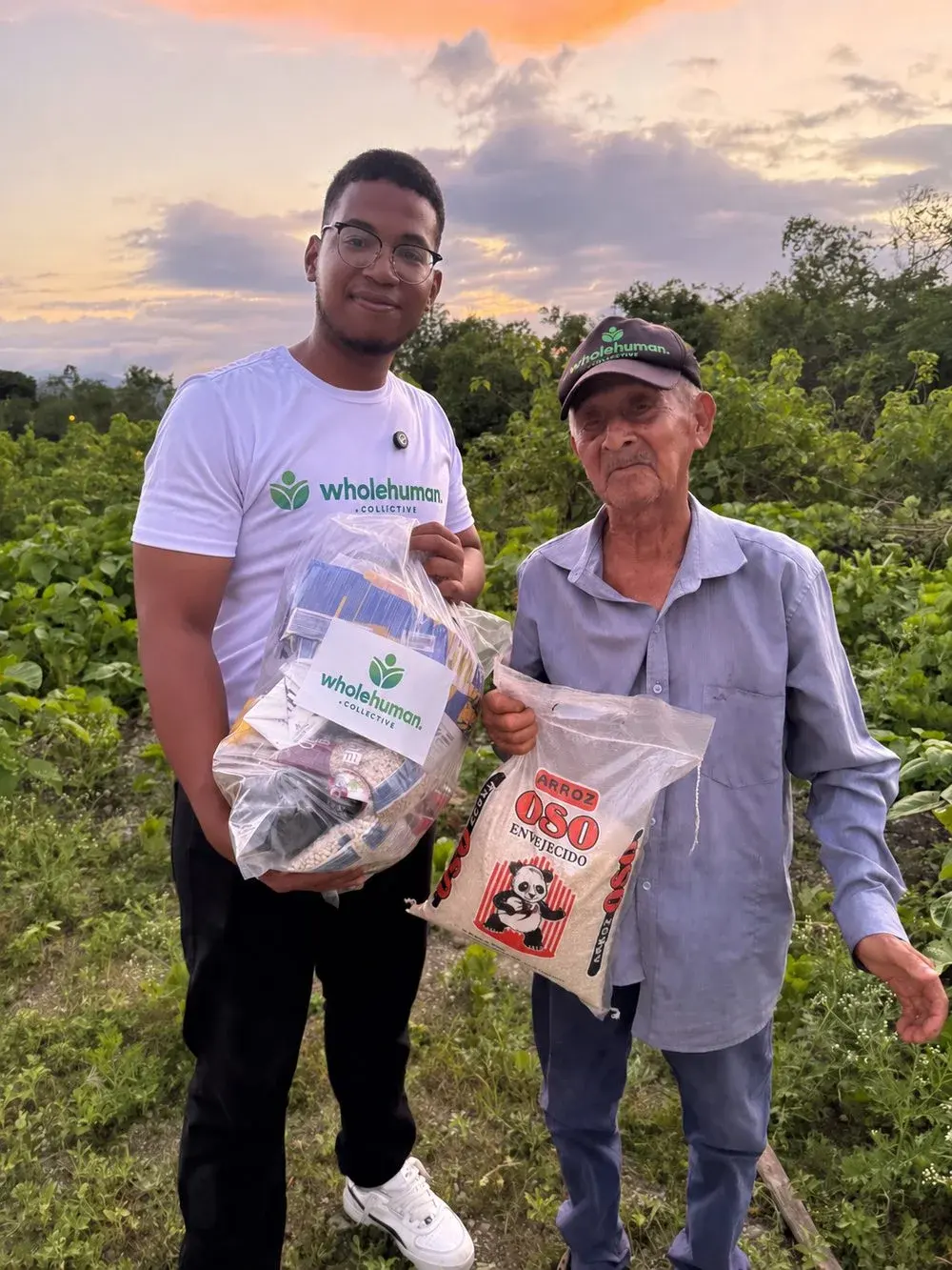 A Wholehuman volunteer hand-delivering an essentials kit